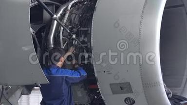 工程师，技术人员用手电筒检查喷气发动机。